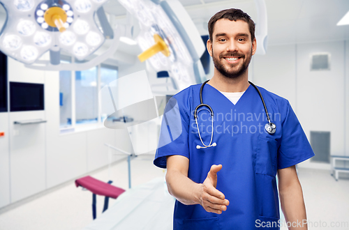 Image of male doctor giving hand for handshake at hospital