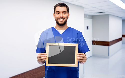 Image of happy smiling male doctor or nurse with chalkboard