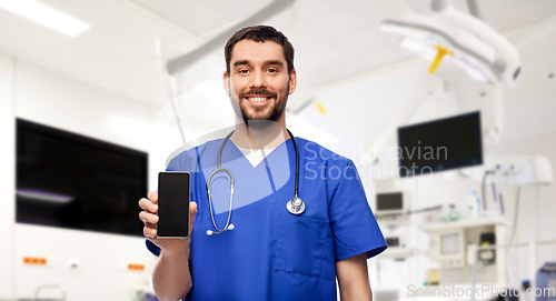 Image of smiling doctor or male nurse with smartphone