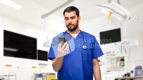 Image of doctor or male nurse using smartphone