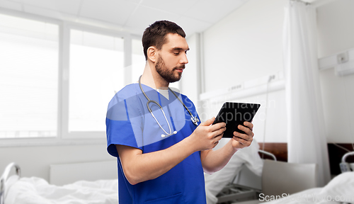 Image of doctor or male nurse using tablet computer