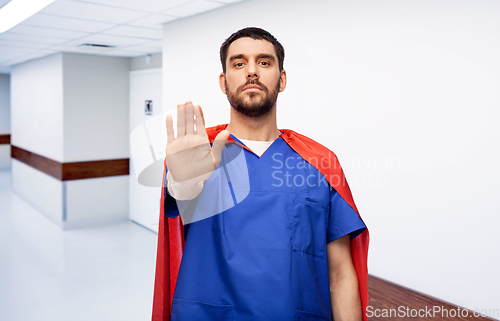 Image of doctor or male nurse in superhero cape at hospital