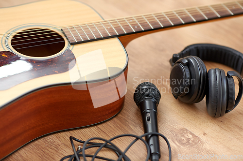 Image of close up of guitar, microphone and headphones