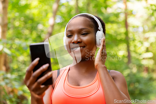 Image of african american woman with headphones and phone