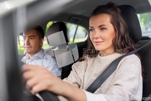 Image of woman and driving school instructor in car