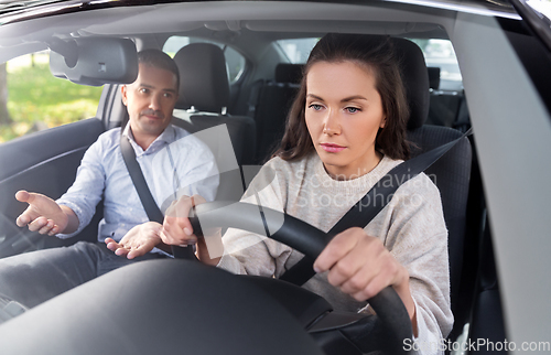 Image of car driving school instructor teaching woman