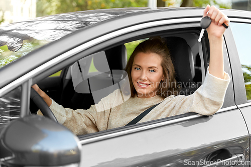 Image of woman or female driver with car key in city