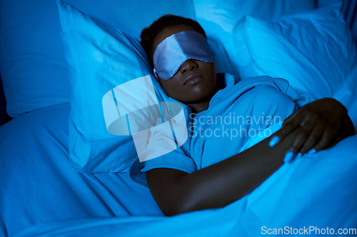 Image of african woman sleeping in bed at home at night