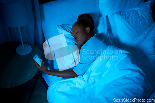 Image of woman awaking because of alarm clock at night