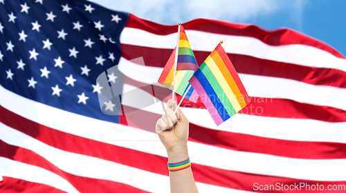 Image of hand with gay pride rainbow flags and wristband