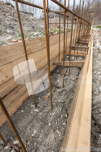 Image of Close-up of the reinforcement of a shallowly buried strip foundation of a low-rise residential building