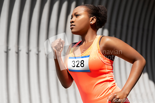 Image of young african american woman running marathon