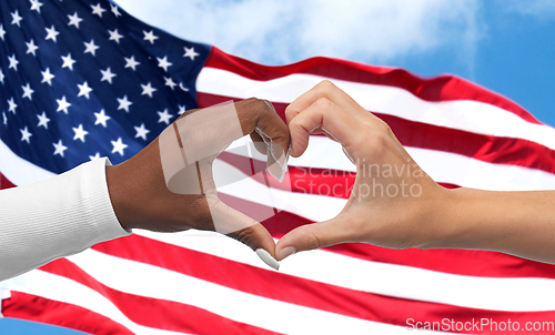 Image of black and white hands making heart gesture