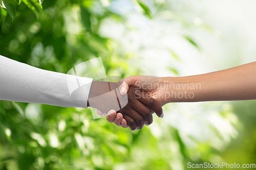 Image of handshake of black and white hands