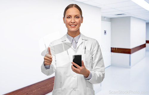 Image of female doctor with smartphone showing thumbs up