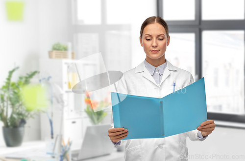 Image of female doctor with folder at hospital