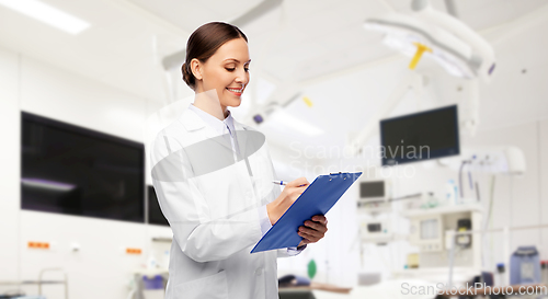 Image of smiling female doctor with clipboard at hospital