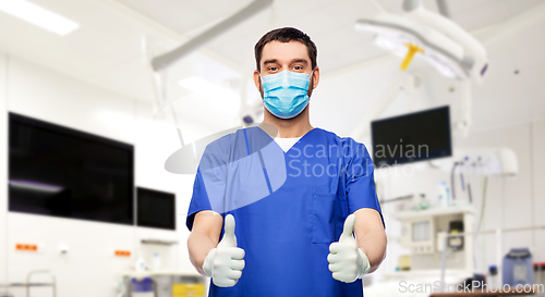 Image of male doctor in mask showing thumbs up