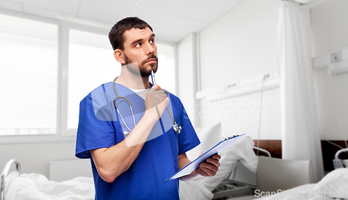 Image of doctor or male nurse with clipboard