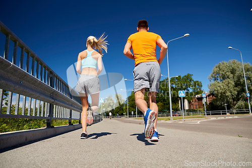 Image of sporty couple running outdoors