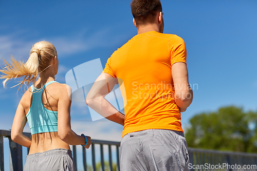 Image of sporty couple running outdoors