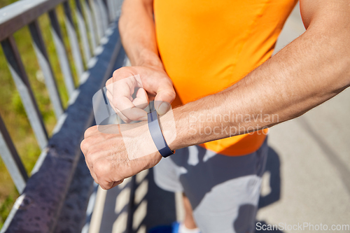 Image of close up of man with fitness tracker outdoors