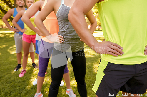 Image of close up of people exercising with trainer at park