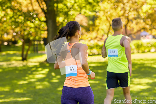 Image of couple of young sportsmen running marathon