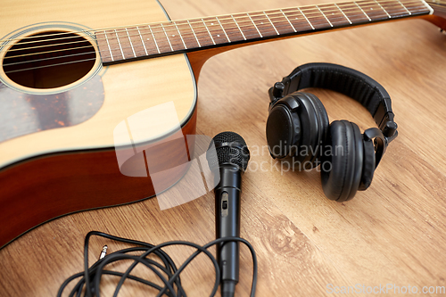 Image of close up of guitar, microphone and headphones