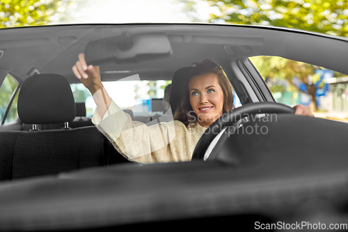 Image of female driver driving car with male passenger