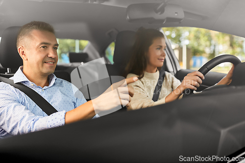 Image of car driving school instructor teaching woman