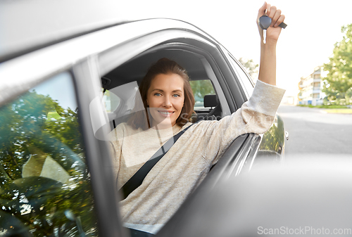 Image of woman or female driver with car key in city