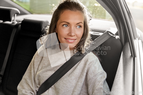 Image of happy smiling woman or female passenger in car