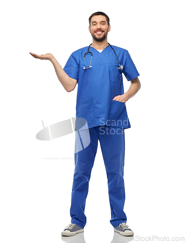 Image of smiling male doctor holding something on hand