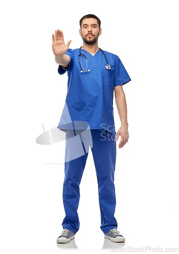 Image of doctor or male nurse showing stop gesture