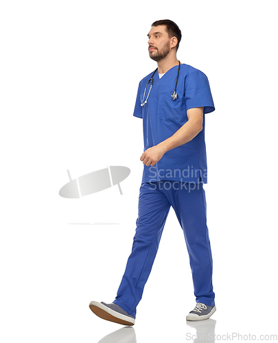 Image of doctor or male nurse with stethoscope walking