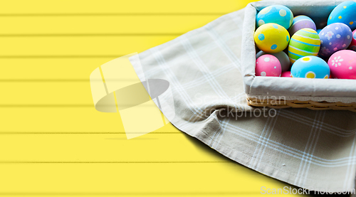 Image of close up of colored easter eggs in basket