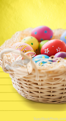 Image of close up of colored easter eggs in basket