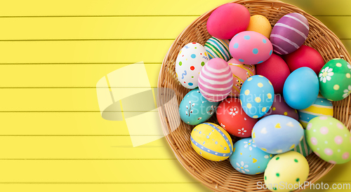 Image of close up of colored easter eggs in basket