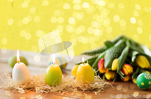 Image of candles in shape of easter eggs and tulip flowers