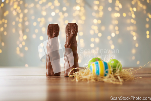 Image of easter eggs in straw nest and chocolate bunnies