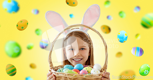 Image of happy girl with colored easter eggs on yellow