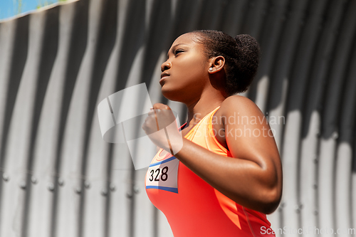 Image of young african american woman running marathon