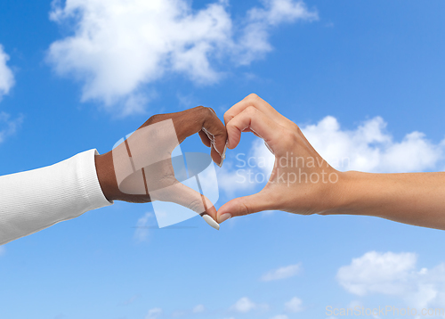 Image of black and white hands making heart gesture