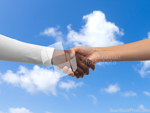 Image of handshake of black and white hands