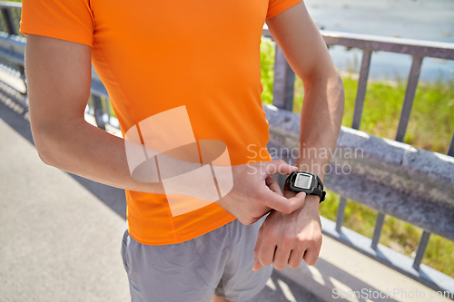 Image of close up of man with fitness tracker outdoors