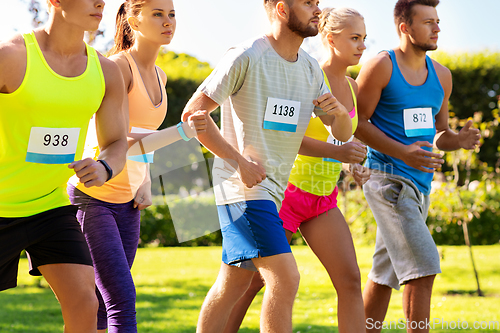 Image of sportsmen with badge numbers on start of race