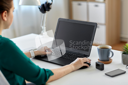 Image of woman with laptop working at home office