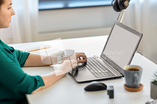 Image of woman with laptop working at home office