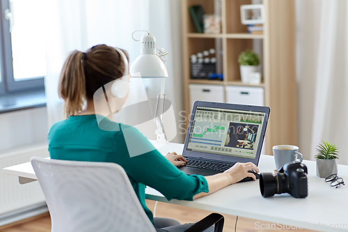 Image of woman with video editor program on laptop at home